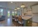 Stylish kitchen island with bar stool seating, pendant lighting, and open access to the backyard patio at 15216 Shallow Ridge Rd, Charlotte, NC 28278