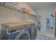 Laundry room featuring a front-loading washer and dryer and plenty of storage space at 15216 Shallow Ridge Rd, Charlotte, NC 28278