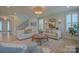 Bright living room with stylish furniture, a round wooden coffee table, and an eye-catching decorative rug at 15216 Shallow Ridge Rd, Charlotte, NC 28278