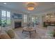 Open-concept living room with fireplace, dining area, and modern kitchen, creating a seamless flow for living at 15216 Shallow Ridge Rd, Charlotte, NC 28278