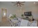 Living room featuring a ceiling fan, television, and access to the hallway at 15216 Shallow Ridge Rd, Charlotte, NC 28278