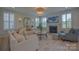 Bright and airy living room with fireplace and large windows, furnished with a sofa and armchairs at 15216 Shallow Ridge Rd, Charlotte, NC 28278