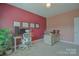 Functional office room with modern desk, neutral decor and house plant at 15216 Shallow Ridge Rd, Charlotte, NC 28278