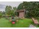 Inviting outdoor stage area with synthetic turf, comfortable seating, and lush landscaping at 15216 Shallow Ridge Rd, Charlotte, NC 28278