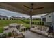 Covered patio with ample seating and a view of the lawn at 15216 Shallow Ridge Rd, Charlotte, NC 28278