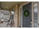 Charming front porch seating area with a wreath on the front door at 15216 Shallow Ridge Rd, Charlotte, NC 28278