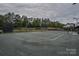 Well maintained tennis courts with nets, surrounded by mature trees, providing a scenic view at 15216 Shallow Ridge Rd, Charlotte, NC 28278