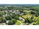 Expansive aerial view of the neighborhood featuring mature trees and manicured lawns at 18745 Bluff Point Rd, Cornelius, NC 28031