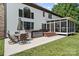 Backyard with a patio set, hot tub, screened porch, and ample green space at 18745 Bluff Point Rd, Cornelius, NC 28031