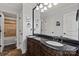 Elegant bathroom with double vanity, granite countertop, and tiled shower/tub combination at 18745 Bluff Point Rd, Cornelius, NC 28031
