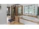 Bathroom featuring a glass shower, soaking tub, and decorative window at 18745 Bluff Point Rd, Cornelius, NC 28031