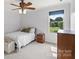 Cozy bedroom with a neutral color scheme, window view, and carpet flooring at 18745 Bluff Point Rd, Cornelius, NC 28031