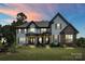 Inviting two-story home with lush lawn, stone details, and a welcoming front porch at 18745 Bluff Point Rd, Cornelius, NC 28031