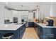 Modern kitchen boasts an island with seating, stainless steel appliances, and white cabinetry at 18745 Bluff Point Rd, Cornelius, NC 28031