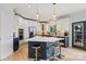 Spacious kitchen featuring an island with seating, stainless steel appliances, and white cabinetry at 18745 Bluff Point Rd, Cornelius, NC 28031