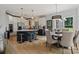 Bright open kitchen with an island, stainless steel appliances, and adjacent dining area at 18745 Bluff Point Rd, Cornelius, NC 28031