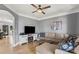 Relaxing living room with hardwood floors, a comfortable sectional sofa, and a TV with an entertainment center at 18745 Bluff Point Rd, Cornelius, NC 28031
