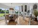 Bright open living area with hardwood floors and large windows overlooking the yard at 18745 Bluff Point Rd, Cornelius, NC 28031