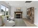 Inviting living room with a cozy fireplace, hardwood floors, natural light, and comfortable seating at 18745 Bluff Point Rd, Cornelius, NC 28031