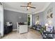 Well-lit home office with a ceiling fan, large window, and ample space for a desk and shelving at 18745 Bluff Point Rd, Cornelius, NC 28031