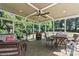 Relaxing screened porch with comfortable seating, a ceiling fan, and views of the backyard at 18745 Bluff Point Rd, Cornelius, NC 28031