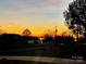 Scenic street view at sunset showing trees, street lights, and single Gathering homes at 18745 Bluff Point Rd, Cornelius, NC 28031