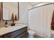 Bathroom with modern countertop, dark brown cabinets, and shower with white curtain at 20216 Shaffer Bach Ln, Charlotte, NC 28277