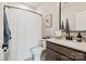 Bathroom featuring a modern countertop, dark brown cabinets, and shower with a curtain at 20216 Shaffer Bach Ln, Charlotte, NC 28277