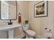 Cozy bathroom featuring a pedestal sink, toilet, and framed artwork at 20216 Shaffer Bach Ln, Charlotte, NC 28277