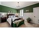 Stylish bedroom with a dark wood four-poster bed, green walls, and white trim at 20216 Shaffer Bach Ln, Charlotte, NC 28277