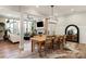 Spacious dining room with wood floors, elegant lighting, and open view to living area at 20216 Shaffer Bach Ln, Charlotte, NC 28277