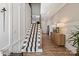 Bright foyer with hardwood floors, paneled walls, stairway, and decorative furnishings at 20216 Shaffer Bach Ln, Charlotte, NC 28277