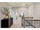 Bright hallway featuring a decorative chest and an open doorway leading to a bedroom sitting area at 20216 Shaffer Bach Ln, Charlotte, NC 28277