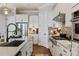 Spacious kitchen features a large sink, stainless steel appliances, and ample white cabinetry at 20216 Shaffer Bach Ln, Charlotte, NC 28277
