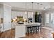 Modern kitchen features white cabinets, stone countertops, and a kitchen island with seating at 20216 Shaffer Bach Ln, Charlotte, NC 28277