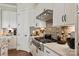 Close-up shot showcases a stainless steel gas range with a brick backsplash and custom cabinetry at 20216 Shaffer Bach Ln, Charlotte, NC 28277
