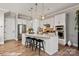 Bright kitchen boasts white cabinetry, a large island with seating, and stainless steel appliances at 20216 Shaffer Bach Ln, Charlotte, NC 28277