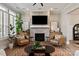 The brick fireplace anchors this living room with stylish decor and lots of natural light at 20216 Shaffer Bach Ln, Charlotte, NC 28277