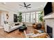 The living room features large windows, modern furniture, and a cozy fireplace at 20216 Shaffer Bach Ln, Charlotte, NC 28277