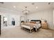 Large main bedroom boasts a decorative light fixture, sitting area, paneled walls, and hardwood floors at 20216 Shaffer Bach Ln, Charlotte, NC 28277
