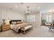 Spacious main bedroom featuring a decorative light fixture, a sitting area, and paneled walls at 20216 Shaffer Bach Ln, Charlotte, NC 28277