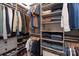 Well-organized walk-in closet with shelves, rods, and ample storage for clothes and accessories at 20216 Shaffer Bach Ln, Charlotte, NC 28277