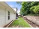 Backyard featuring a well-maintained lawn and retaining wall, offering a serene and private outdoor space at 207 Crystal Springs Ln, Shelby, NC 28150