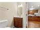 Bathroom vanity and toilet with a view to the kitchen at 207 Crystal Springs Ln, Shelby, NC 28150