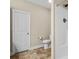 Bathroom featuring a toilet, shower, and door with neutral colors for a clean design at 207 Crystal Springs Ln, Shelby, NC 28150