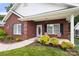 Charming brick home featuring a cozy front porch with tasteful landscaping and decorative front door at 207 Crystal Springs Ln, Shelby, NC 28150