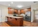 Bright kitchen with stainless steel appliances, granite countertops, and wood cabinets at 207 Crystal Springs Ln, Shelby, NC 28150