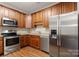 Well-equipped kitchen with stainless steel appliances, wood cabinets, and granite countertops at 207 Crystal Springs Ln, Shelby, NC 28150