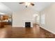 Open layout with wood flooring, fireplace, and kitchen view with stainless steel appliances at 207 Crystal Springs Ln, Shelby, NC 28150