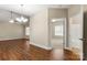 Open living room with wood floors, bright natural light, and a modern light fixture at 207 Crystal Springs Ln, Shelby, NC 28150